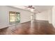 Spacious living room with wood flooring, ceiling fans, and slider to backyard at 4802 W Hayward Ave, Glendale, AZ 85301
