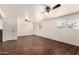 Living room featuring hardwood floors, multiple windows, and ceiling fans at 4802 W Hayward Ave, Glendale, AZ 85301