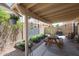 Covered back patio with a picnic table and plants at 4912 W Marco Polo Rd, Glendale, AZ 85308