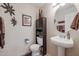 Well decorated bathroom with a pedestal sink, accent mirror and decor at 4912 W Marco Polo Rd, Glendale, AZ 85308