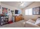 Cozy bedroom featuring a neutral palette, a large window, and a ceiling fan at 4912 W Marco Polo Rd, Glendale, AZ 85308