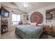 Inviting bedroom with a statement tapestry, TV, and a bright window seat at 4912 W Marco Polo Rd, Glendale, AZ 85308