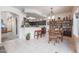 Open kitchen with breakfast bar, dark cabinets, and dining area at 4912 W Marco Polo Rd, Glendale, AZ 85308