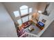 Aerial view of living room featuring a red leather sofa set, high ceilings, and natural lighting at 4912 W Marco Polo Rd, Glendale, AZ 85308
