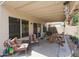 Covered patio with seating area and picnic table, perfect for outdoor relaxation and dining at 4912 W Marco Polo Rd, Glendale, AZ 85308