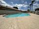 Large in-ground community pool with concrete surround and nearby palm trees at 4912 W Marco Polo Rd, Glendale, AZ 85308