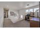 Upstairs hallway with railing, desk area, and ample natural light from multiple windows at 4912 W Marco Polo Rd, Glendale, AZ 85308