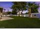 Fully-turfed backyard with manicured landscaping and lighting, with shed for extra storage at 5309 E Hearn Rd, Scottsdale, AZ 85254