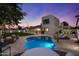 Panoramic view of a backyard featuring a sparkling pool, covered patio, and ample seating areas at 5309 E Hearn Rd, Scottsdale, AZ 85254