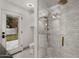 Modern bathroom featuring a glass-enclosed shower, marble tiles, and access to the backyard at 5309 E Hearn Rd, Scottsdale, AZ 85254