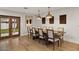 Elegant dining area showcasing hardwood floors, decorative light fixtures and an adjacent glass door to the backyard at 5309 E Hearn Rd, Scottsdale, AZ 85254