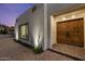 Close up of a stunning, custom double-door entry with brick pavers and manicured landscape at 5309 E Hearn Rd, Scottsdale, AZ 85254