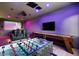 Entertaining game room featuring a foosball table, shuffleboard, a large screen, and comfortable seating at 5309 E Hearn Rd, Scottsdale, AZ 85254