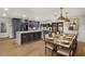 Open concept kitchen with a large waterfall island, stainless appliances, and gray cabinetry adjacent to the dining area at 5309 E Hearn Rd, Scottsdale, AZ 85254