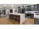 Kitchen with a large island featuring waterfall countertops, stainless steel appliances, and custom cabinetry at 5309 E Hearn Rd, Scottsdale, AZ 85254