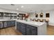 Bright kitchen with gray cabinets, stainless steel appliances, and a large island with seating for casual dining at 5309 E Hearn Rd, Scottsdale, AZ 85254