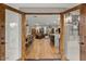 Open doorway showcasing the great room with wood floors, a leather sofa, and a kitchen island at 5309 E Hearn Rd, Scottsdale, AZ 85254