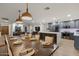 Spacious living area showcasing the kitchen island, dining set and lounge space, all with lots of natural light at 5309 E Hearn Rd, Scottsdale, AZ 85254