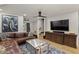 Cozy living area features stylish furnishings, hardwood floors, a ceiling fan, and an elephant painting at 5309 E Hearn Rd, Scottsdale, AZ 85254