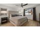 Inviting main bedroom with a large bed, dark wood nightstands, natural light, and rustic ceiling fan at 5309 E Hearn Rd, Scottsdale, AZ 85254