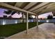 Covered patio view of the expansive turf backyard with shed and perimeter landscape lighting at 5309 E Hearn Rd, Scottsdale, AZ 85254