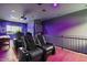 Theater room featuring tiered seating, a projector, and luxurious black leather reclining seats at 5309 E Hearn Rd, Scottsdale, AZ 85254
