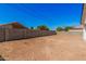Spacious, fenced-in backyard awaiting customization, perfect for creating your ideal outdoor space at 5499 E Red Bird Ln, San Tan Valley, AZ 85140