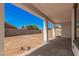 Covered patio overlooks a large, empty, fenced backyard offering a blank canvas for outdoor living at 5499 E Red Bird Ln, San Tan Valley, AZ 85140