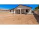 View of the home's rear exterior and covered patio, opening to a large backyard space at 5499 E Red Bird Ln, San Tan Valley, AZ 85140