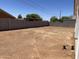 Large, undeveloped backyard with a block fence and desert landscaping is ready for your custom design at 5499 E Red Bird Ln, San Tan Valley, AZ 85140