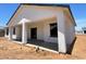 The covered back patio boasts ample space and a modern stucco design, great for outdoor living at 5499 E Red Bird Ln, San Tan Valley, AZ 85140
