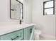 A full bathroom features a vanity with a square mirror, toilet, shower, and black hardware and window at 5499 E Red Bird Ln, San Tan Valley, AZ 85140