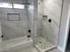Modern bathroom features marble-look tile, stylish black fixtures, and a separate tub and shower at 5499 E Red Bird Ln, San Tan Valley, AZ 85140
