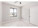 An empty bedroom showcases a black-trimmed window, white walls, marble floors, and closet with sliding doors at 5499 E Red Bird Ln, San Tan Valley, AZ 85140