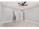 Bedroom with marble flooring, modern ceiling fan, and three doors at 5499 E Red Bird Ln, San Tan Valley, AZ 85140