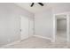 A light-filled bedroom features marble flooring, closet with sliding doors, and a ceiling fan with door to another room at 5499 E Red Bird Ln, San Tan Valley, AZ 85140