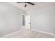 A spacious bedroom with white walls, marble tile floor, ceiling fan, and a closet with a white door at 5499 E Red Bird Ln, San Tan Valley, AZ 85140