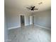 Bright, airy bedroom with neutral walls, tile flooring, ceiling fan, and multiple doorways and a closet at 5499 E Red Bird Ln, San Tan Valley, AZ 85140