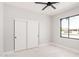 Bedroom with modern ceiling fan, wide closet doors, and exterior view window at 5499 E Red Bird Ln, San Tan Valley, AZ 85140