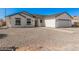 Inviting single-story home with a clean exterior, offering an attached garage and landscaped front yard for charm at 5499 E Red Bird Ln, San Tan Valley, AZ 85140