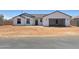 Newly constructed home boasts a white stucco finish, a grey roof, and a convenient two-car garage at 5499 E Red Bird Ln, San Tan Valley, AZ 85140