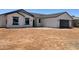 New construction features a white stucco exterior, dark grey trim, and a spacious two-car garage at 5499 E Red Bird Ln, San Tan Valley, AZ 85140