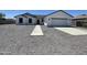 Charming one-story home with a gray gravel yard, concrete walkway and driveway, and a two car garage at 5499 E Red Bird Ln, San Tan Valley, AZ 85140