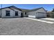 Charming one-story home with a gray gravel yard, concrete walkway and driveway, and a two car garage at 5499 E Red Bird Ln, San Tan Valley, AZ 85140