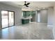 Bright, open-concept living area with light grey tile floors flows into the kitchen at 5499 E Red Bird Ln, San Tan Valley, AZ 85140