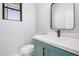 Stylish powder room with a modern vanity, sleek faucet, and framed mirror at 5499 E Red Bird Ln, San Tan Valley, AZ 85140