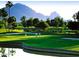 Picturesque golf course view featuring lush green fairways, trees, water, and a backdrop of mountains, enhancing its appeal at 7120 N Via De La Sendero --, Scottsdale, AZ 85258