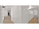 A long white hallway leads to other rooms with light wood floors and natural light at 7120 N Via De La Sendero --, Scottsdale, AZ 85258