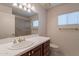 Well-lit bathroom features a large vanity, a window, and a glass enclosed shower at 8171 E Del Caverna Dr, Scottsdale, AZ 85258