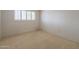 Carpeted bedroom offers a large window with bright light at 8171 E Del Caverna Dr, Scottsdale, AZ 85258